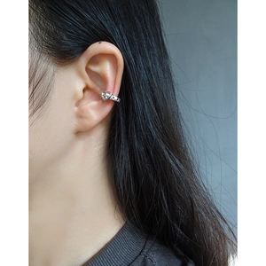 Minimalist heart-shaped silver ear cuff shown on model in a sleek Korean style