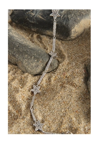 Macro shot of silver star bracelet with cubic zirconia set on natural stones