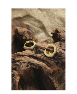 Close-up of gold S925 silver huggie earrings with row of white cubic zirconia stones