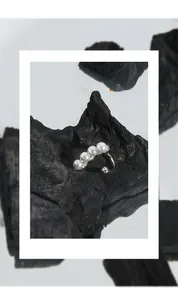Close-up of minimalist S925 silver pearl ring on charcoal background with sleek luster