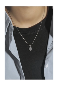 Detail of S925 sterling silver moonstone pendant necklace worn on minimalist casual shirt