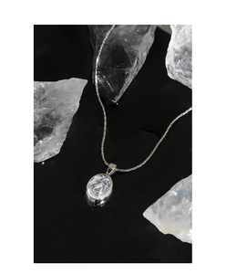 Close-up of S925 silver necklace featuring an oval pendant with icy crackle texture stone