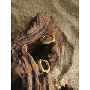 Elegant gold plated S925 silver hoop earrings with clear cubic zirconia on natural wood