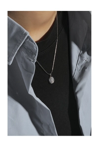 Detailed view of the S925 silver necklace featuring an oval translucent moonstone pendant