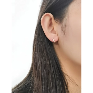 Elegant gold S925 sterling silver huggie earrings with pavé crystals on earlobe