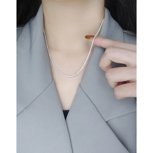 Sparkling S925 sterling silver cauliflower chain necklace worn on a classic grey blazer