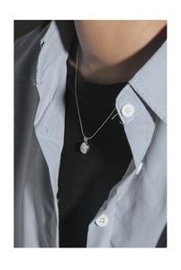 Detail of S925 sterling silver necklace with oval moonstone pendant on a model
