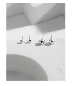 Detailed view of S925 sterling silver pebble earrings in two sizes on a white stand