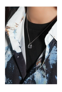 Detail of S925 silver necklace featuring a transparent geometric zircon lock pendant