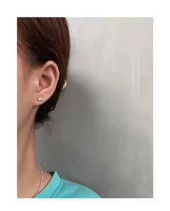 Minimalist bean-shaped S925 sterling silver stud earring shown on a model's ear