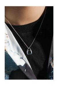 Detail of a minimalist square blue zircon pendant necklace on S925 silver chain