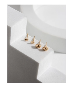 Macro shot of S925 sterling silver organic pebble stud earrings with matte gold texture