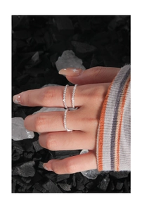 Close-up of S925 sterling silver layered ring with sparkling white cubic zirconia stones