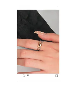Close-up of a double-layered S925 silver ring featuring a textured golden heart charm