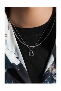 Close-up of double-layered S925 silver necklace with square zircon padlock pendant