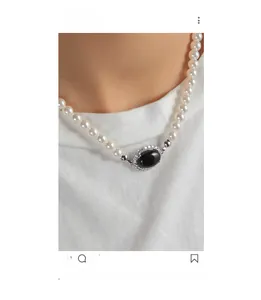 Detail of vintage S925 silver necklace with black agate pendant and white pearls