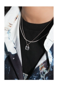 Detail of a minimalist S925 silver double-layer necklace with a square crystal pendant