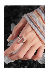 Macro shot of S925 silver ring featuring a large rectangular zircon on a mineral background