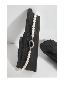 Detail of S925 silver necklace featuring white pearls and black onyx pendant with crystals