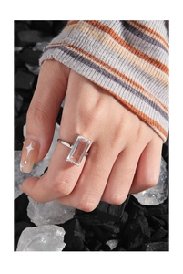Macro shot of S925 silver ring featuring a large rectangular clear zircon on model's hand