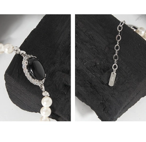 Detail of S925 sterling silver stamp on pearl necklace with black agate pendant