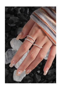 Detailed view of three minimalist S925 sterling silver rings with micro-pave crystals