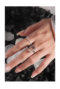 Detailed view of stacked S925 silver rings with large rectangular zircon and pave bands