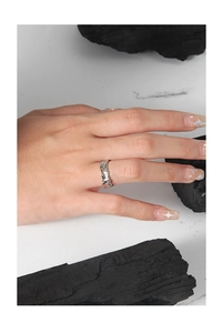 Close-up of S925 silver ring featuring irregular lava texture worn on finger