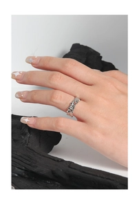 Macro detail of S925 silver ring featuring irregular lava texture and red zircon accent