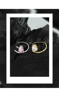 Detail of pear-cut pink and white zircon stones on S925 silver rings with twisted bands