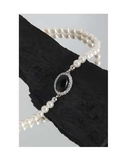Detailed macro view of S925 sterling silver pearl necklace with black onyx oval pendant