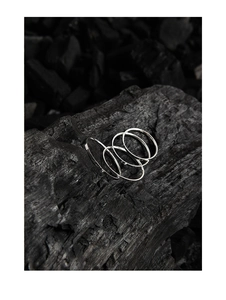 Macro view of 1mm textured S925 sterling silver minimalist rings stacked on charcoal