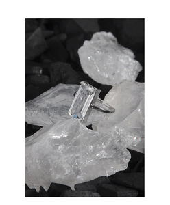 Macro shot of S925 silver ring featuring a large emerald-cut zircon on artistic background