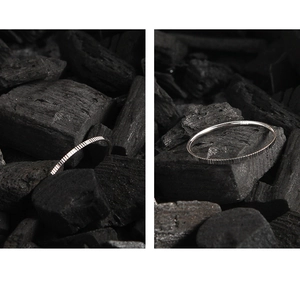 Macro detail of S925 sterling silver minimalist 1mm ring with vertical texture finish