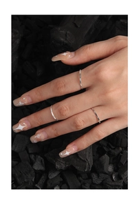 Close-up of three 1mm textured S925 sterling silver minimalist rings on a model hand