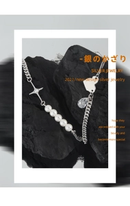 Artistic detail of S925 silver necklace with pearls and cross charm on volcanic rock