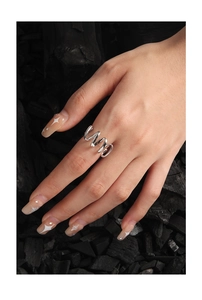 Detail shot of a silver S925 minimalist wavy twisted ring worn on a finger