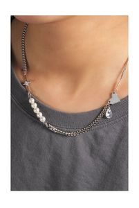 Detail of S925 silver necklace with heart, cross star charms and white pearls