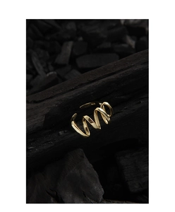 Macro detail of gold spiral S925 sterling silver ring showing its hallmark and texture