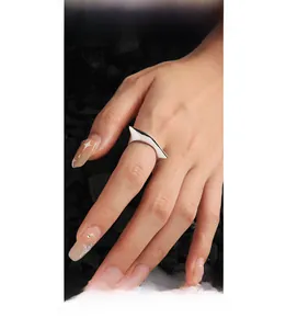 Close-up of geometric S925 silver open ring with irregular polished finish on finger
