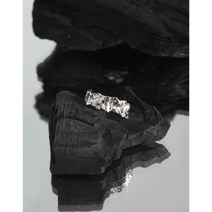 Irregular lava textured S925 silver ring with red zircon stones on charcoal base