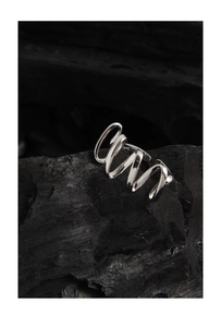 Close-up of S925 sterling silver stamp on minimalist twisted wave ring band