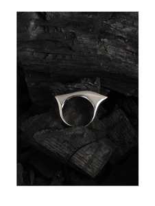 Macro detail of geometric S925 sterling silver ring on charcoal background