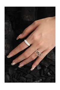 Macro view of textured sand-finish and polished spiral S925 sterling silver rings