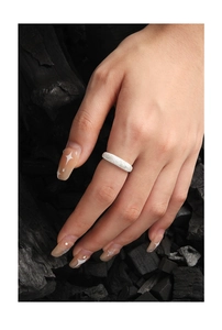 Macro detail of S925 sterling silver ring with frosted texture on dark background