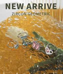 Macro detail of S925 sterling silver rings with colorful zircons on orange glass