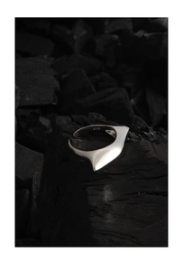 Macro view of polished S925 sterling silver ring showing abstract irregular wing shape