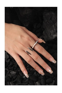 Macro detail of irregular S925 silver multi-finger ring with polished spiky finish