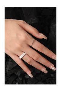 Macro shot of S925 sterling silver sand-textured and ribbed stacking rings for women