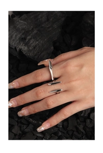 Macro detail of geometric S925 silver open rings on charcoal textured background